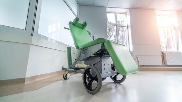 Photo wheel chair in hospital corridor. modern wheelchair. health and surgery concept.