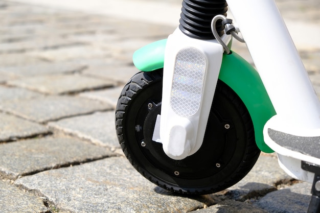 Wheel of Electric scooter on pavement at old City Center.