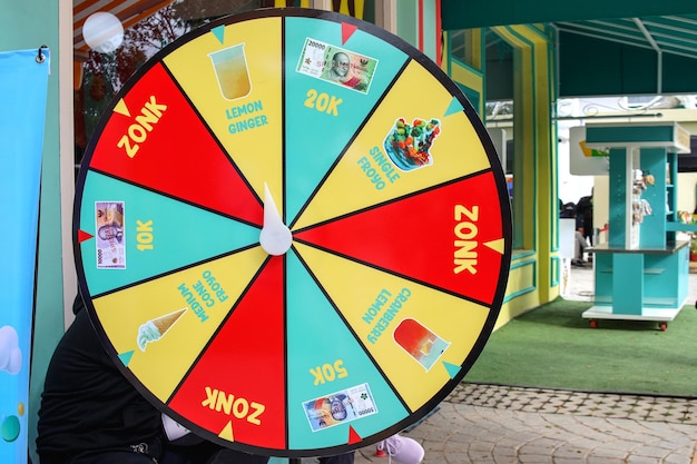 Photo the wheel of fortune hung up in front of cafe restaurant spinning door prize concept