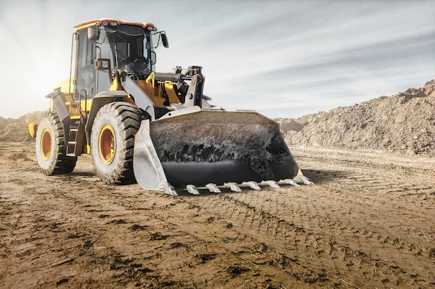 Wheel front loader or bulldozer at a construction site in a quarry Powerful modern equipment for earthworks Construction site Rental of construction equipment