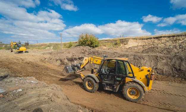 Wheel loader excavator works at construction site