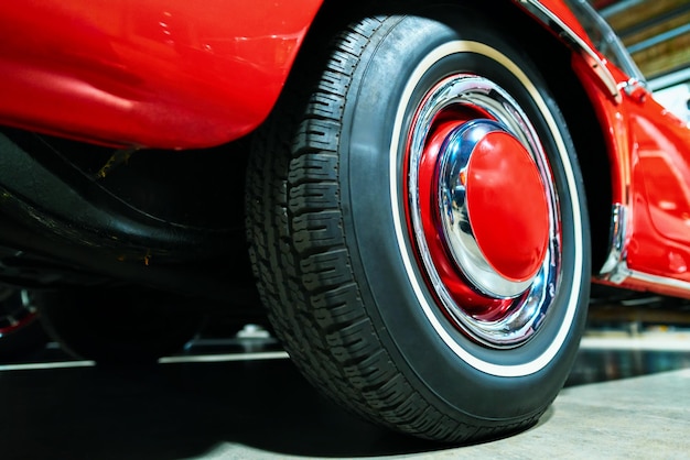 Wheel of red Retro car in the garage in Berlin, Germany