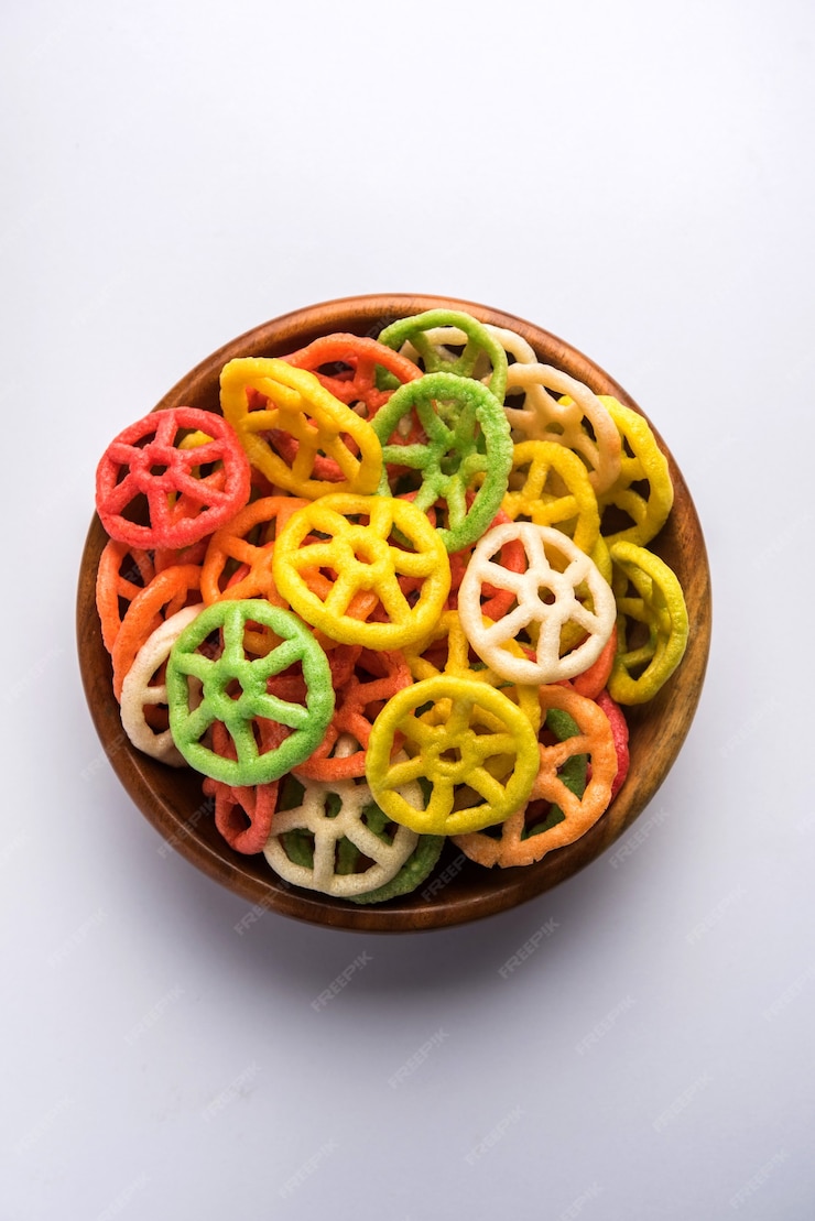 Premium Photo | Wheel shape colourful fryums papad is a crunchy snack ...