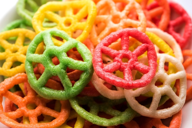 Wheel shape colourful Fryums Papad is a crunchy Snack Pellets served in a bowl