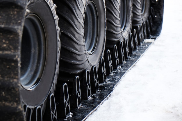 Wheel of snowmobile on snow, closeup