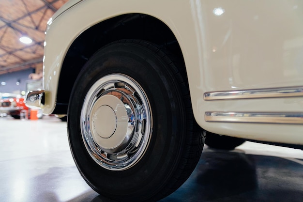 Wheel of white vintage classic car in Berlin of Germany. Details of auto