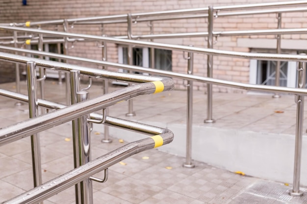 Wheelchair entry outdoor object nobodyway of wheelchair
concrete ramp way with stainless steel handrail with disabled sign
on the floor for support wheelchair of disabled peopleselective
focus