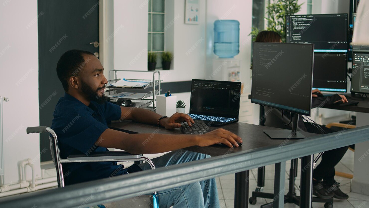 Premium Photo | Wheelchair user software engineer working on server ...