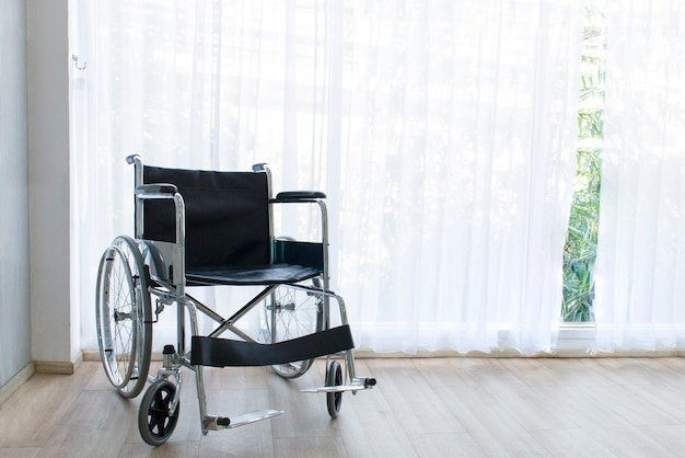 Wheelchairs waiting for services on hospital room with sun light near window.