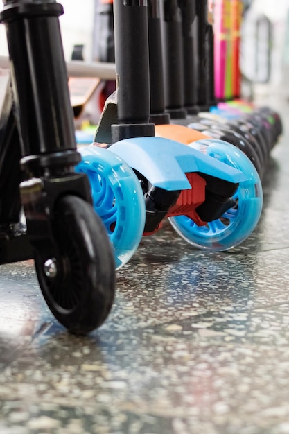 Wheels of various scooters in a row