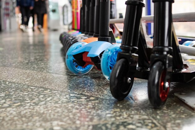 Wheels of various scooters in a row