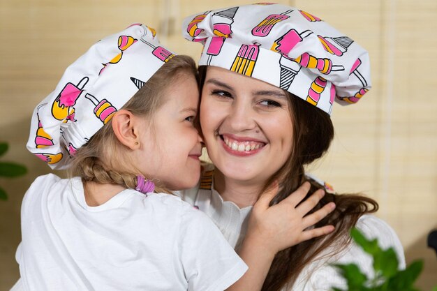 Photo while eating homemade pizza a fiveyearold daughter hugs her mother warmly thus reciprocating her mothers love for her child