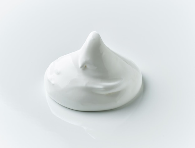 Whipped egg whites cream on white background