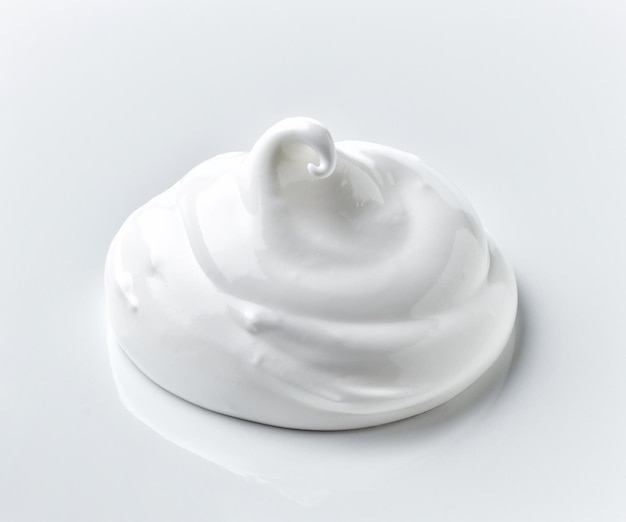 Whipped egg whites cream on white background