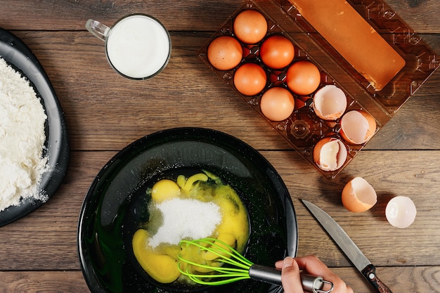 Whipping eggs. Chef hands close-up whisk eggs 