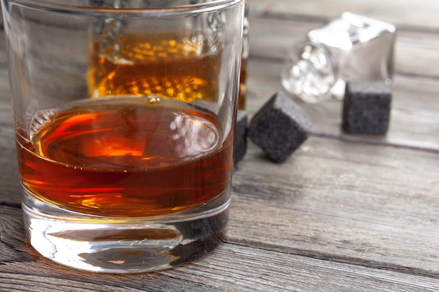 Whiskey beverage in glass with stone. Alcohol 