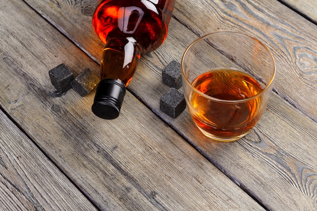 Whiskey beverage in glass with stone. Alcohol 