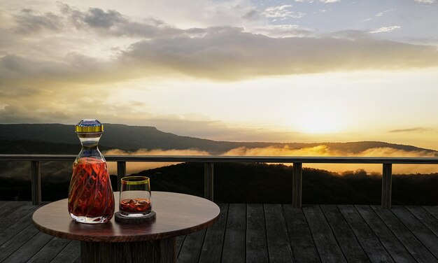 A whiskey or brandy bottle with a clear bottle design and clear glass placed on a wooden table Wooden balcony for mountain views The sunrise And morning fog 3D Rendering