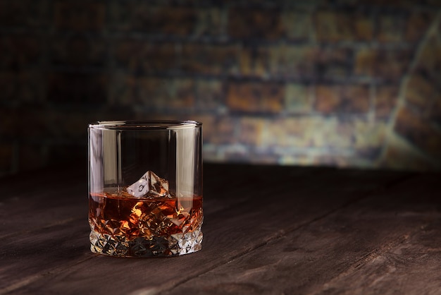 Whiskey drink on dark wooden table