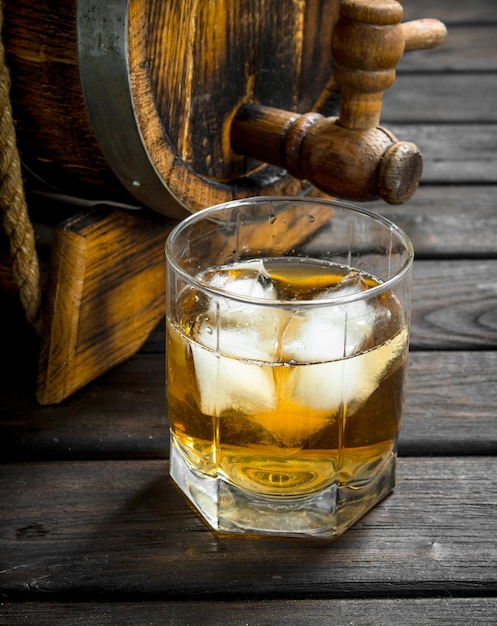 Whiskey in a glass and a barrel