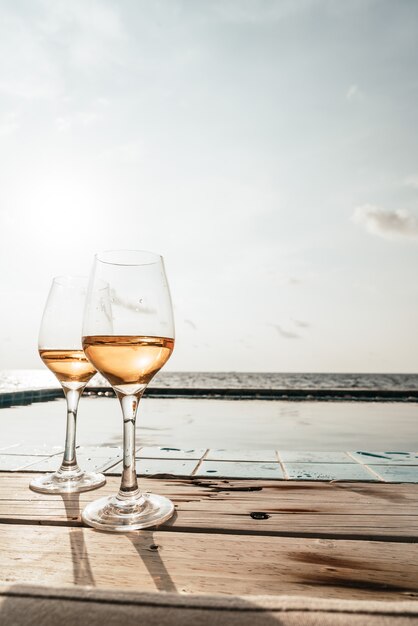 whiskey glass with swimming pool and sea