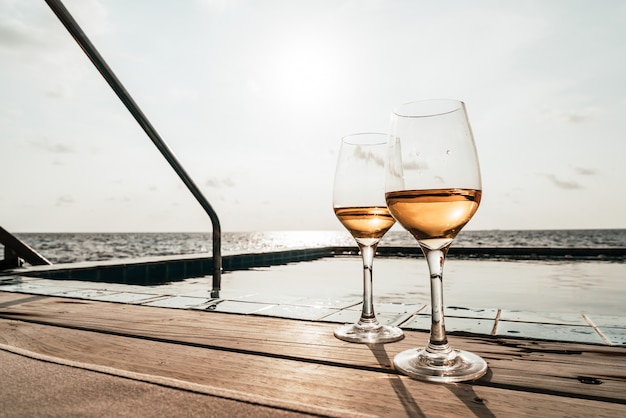 whiskey glass with swimming pool and sea