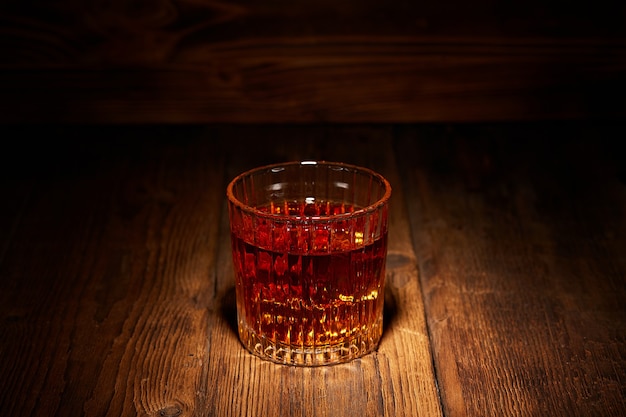 Whiskey in a glass on wooden table