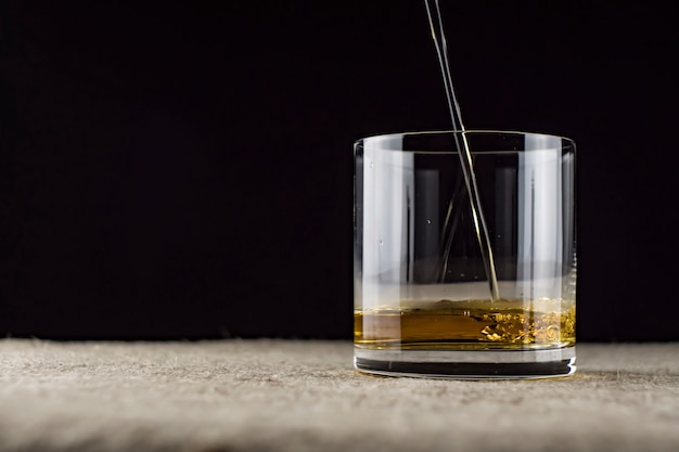 Whiskey is poured into a glass