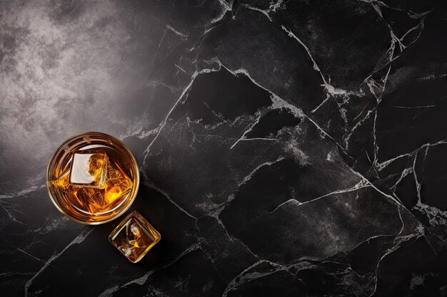 Photo whiskey on rocks atop black table seen from above with space