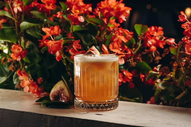 Whiskey sour cocktail with fig in old fashioned glass