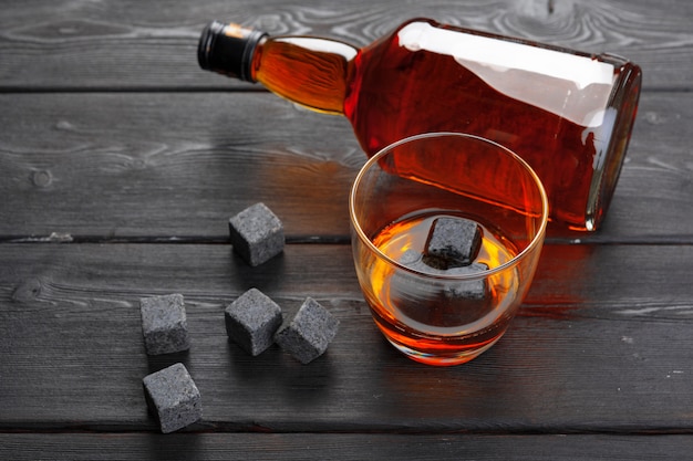 Whiskey and whiskey stones on a wooden surface table