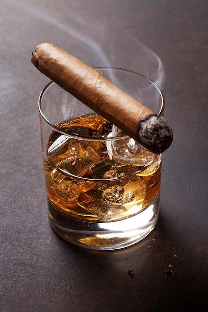 Whiskey with ice and cigar