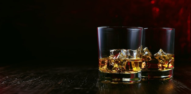 Whiskey with ice in modern glasses