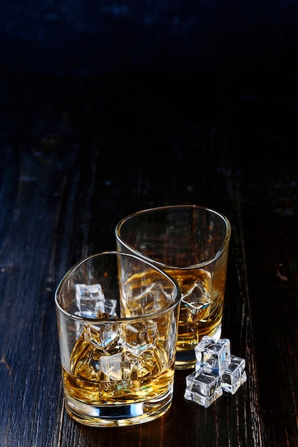 Whiskey with ice in modern glasses