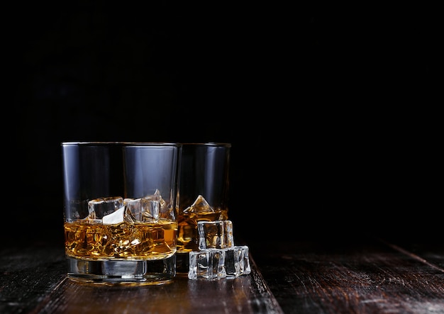 Whiskey with ice in modern glasses