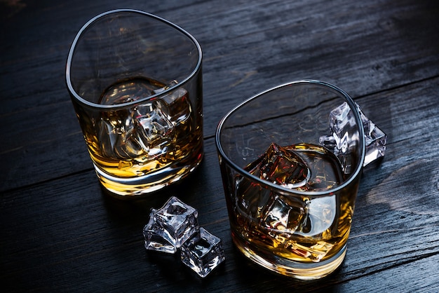 Whiskey with ice in modern glasses