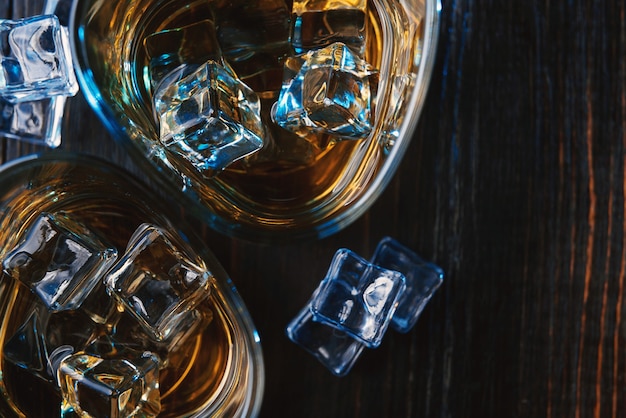 Whiskey with ice in modern glasses