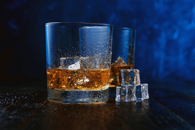 Whiskey with ice in modern glasses