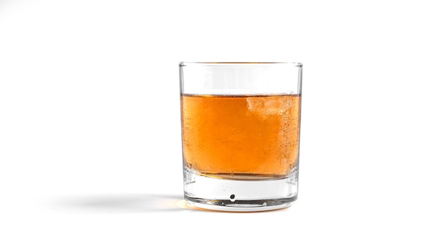 Whiskey with ice on white