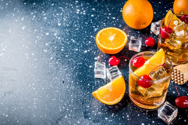 Whiskey with orange and cocktail cherries