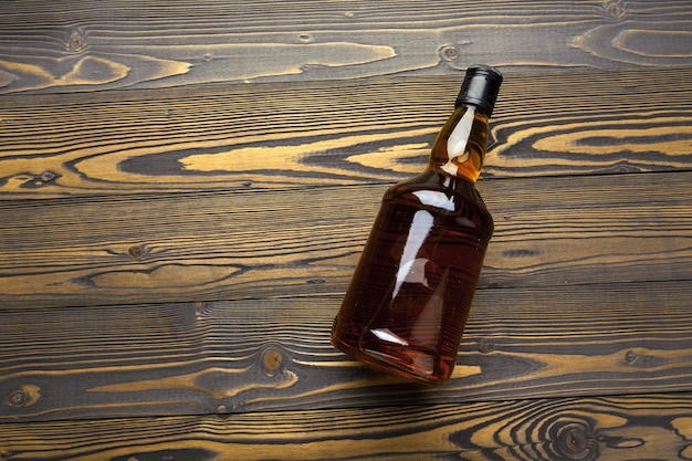 Whisky bottle on dark wooden  flat lay