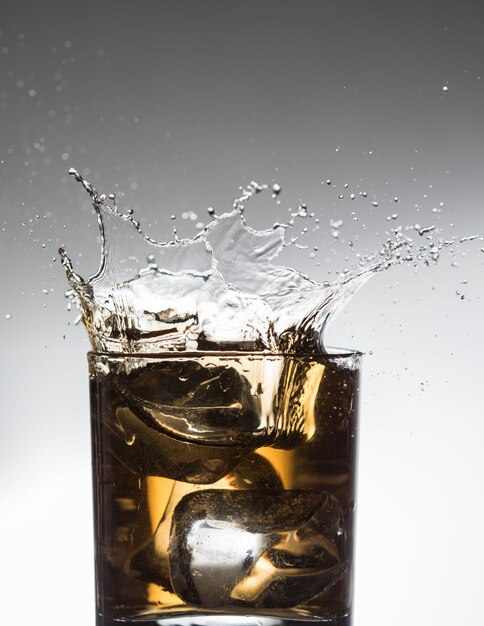 Whisky cocktail liquor splash alcohol in glass 