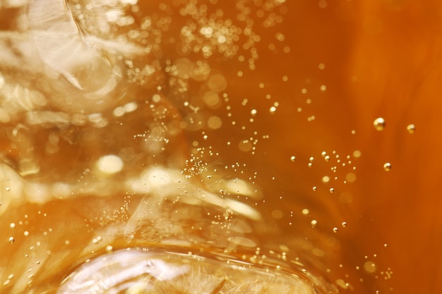 Whisky and ice in glass, bubble float