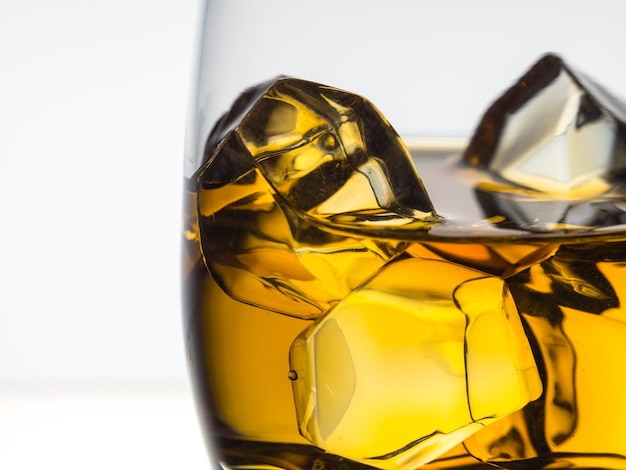 Whisky on the rocks on in a tumbler white background