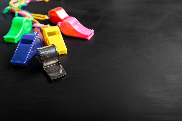 Whistle on blackboard background