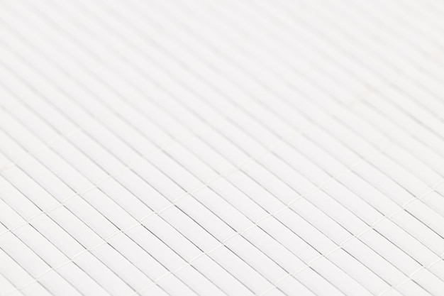 White abstract background made of stitched wooden strips forming a tablecloth