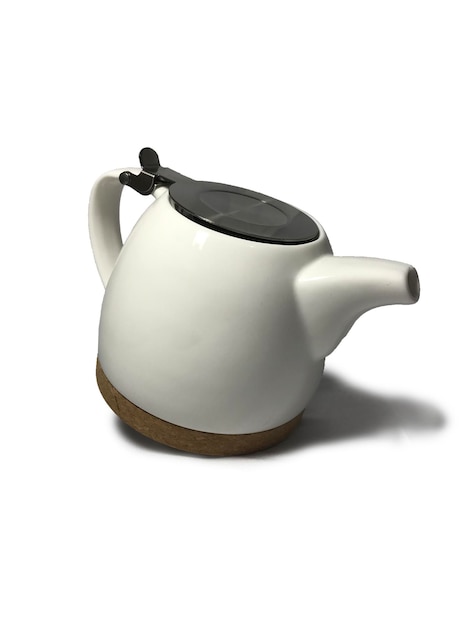 Photo white aesthetic ceramic teapot and wooden bottom on white background