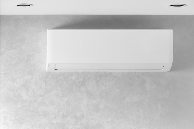 White air conditioner on a gray wall in a house apartment copy space