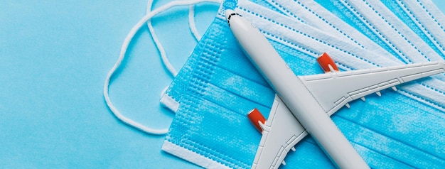 A white airplane on top of some blue medical face masks