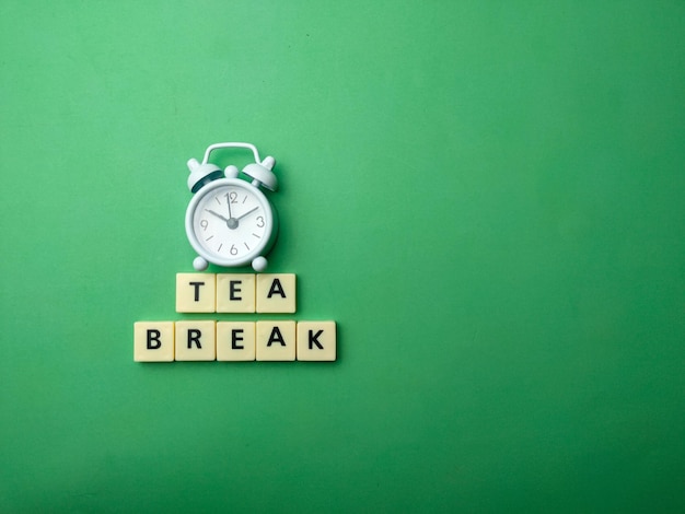 White alarm clock with the word TEA BREAK